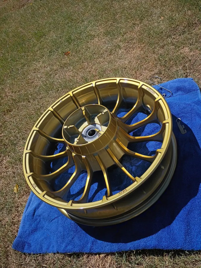 Spoked motorcycle wheel powder coated in gold