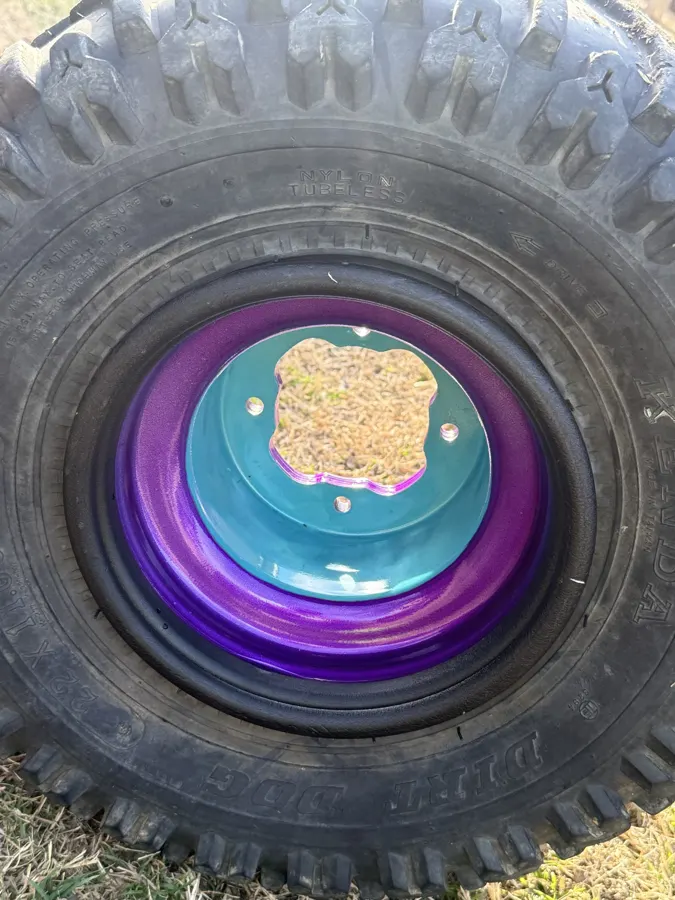 ATV wheel powder coated in teal with purple outer lip