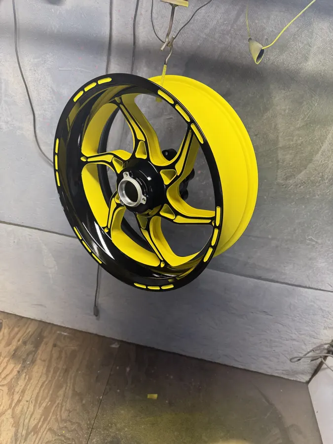 Motorcycle wheel powder coated in bright yellow with black spokes